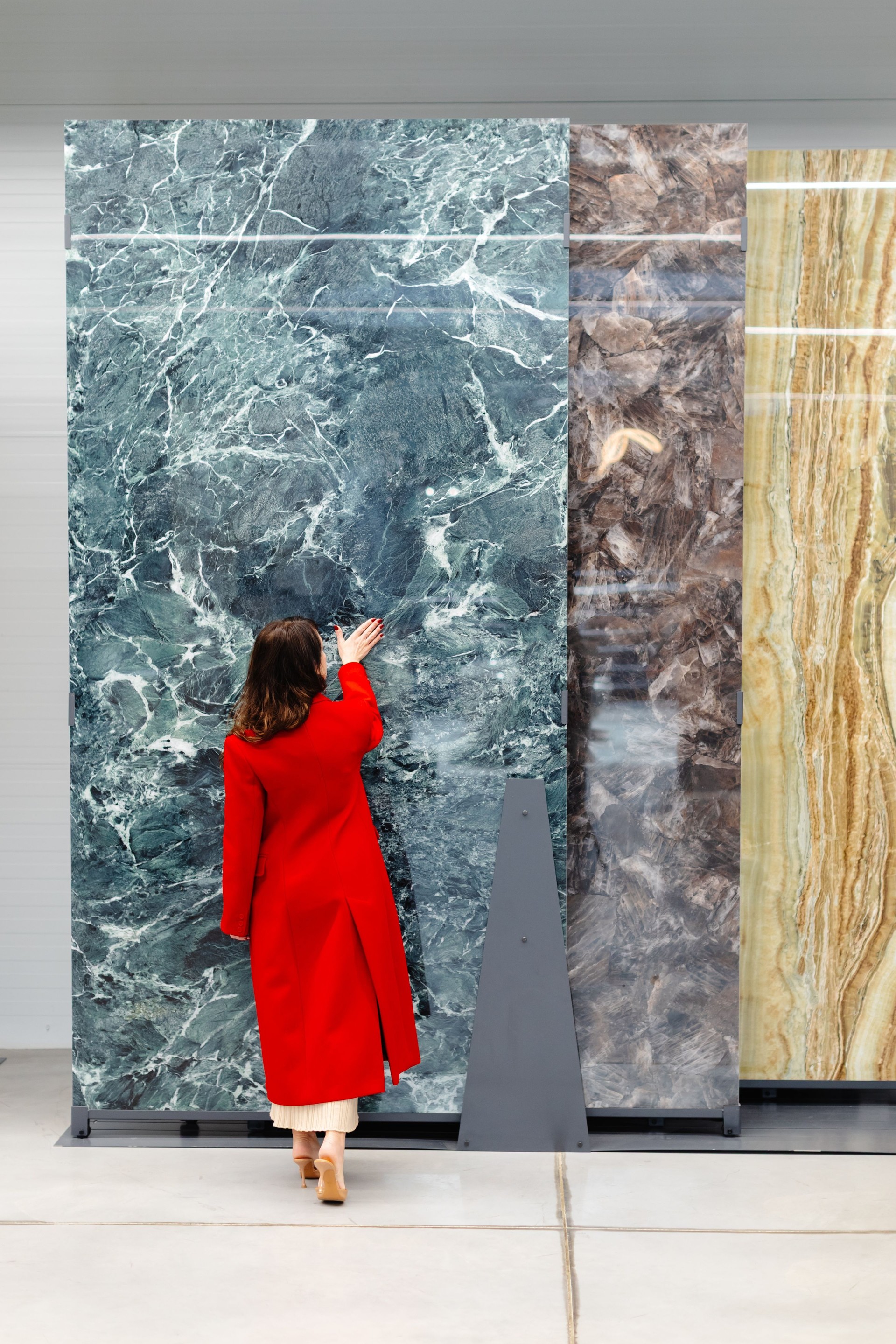 Interior designer choosing marble slabs for new project in warehouse